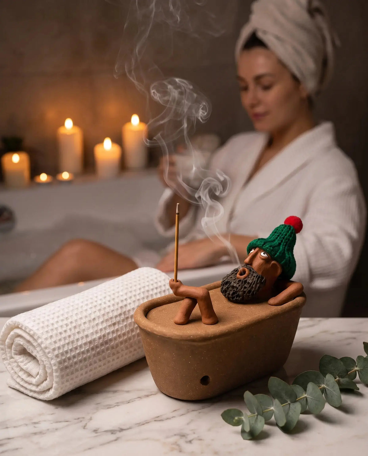 Lazy Bath Man incense burner in a candlelit bathroom spa
