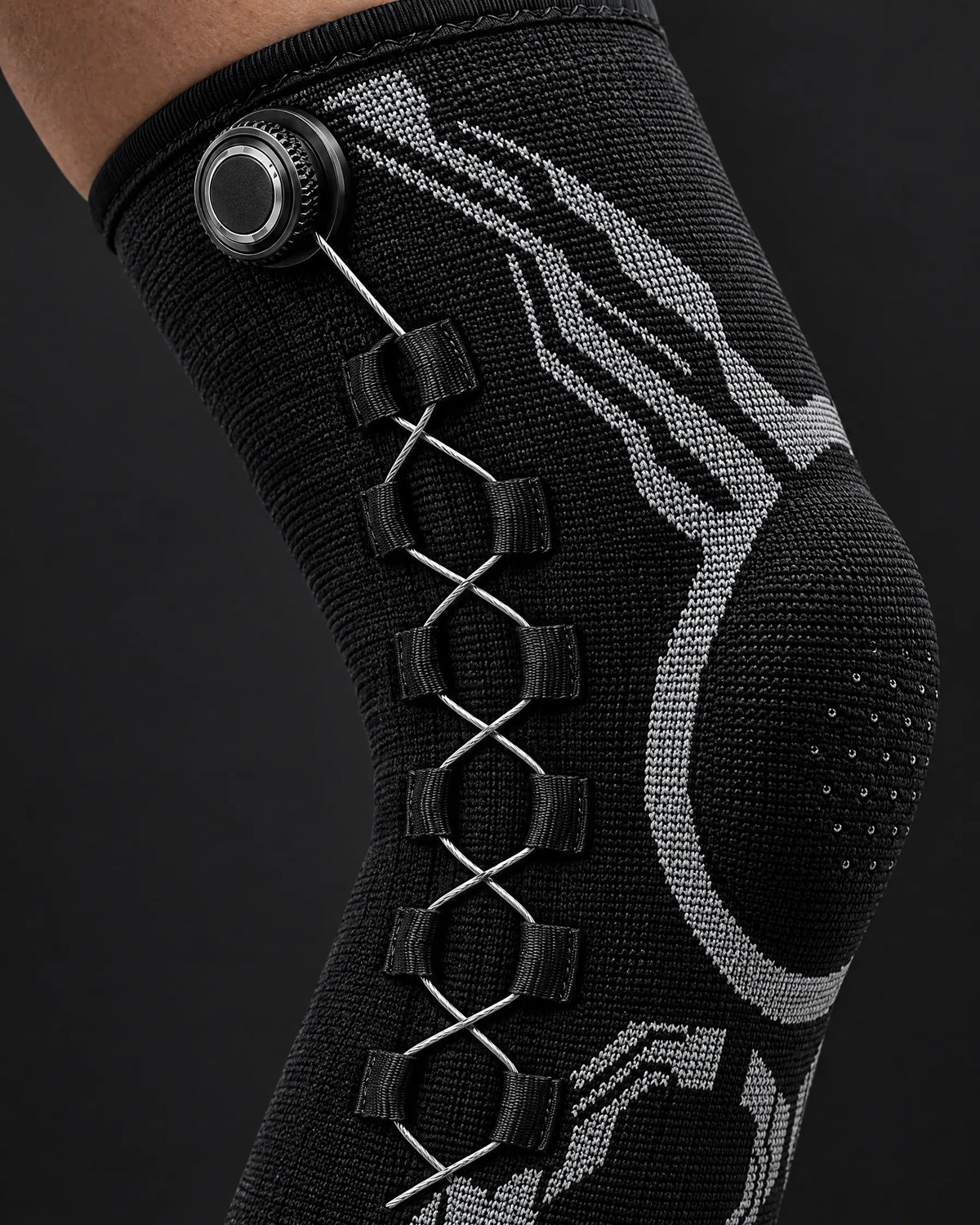 Close-up of the dial and cable lacing on the knee sleeve