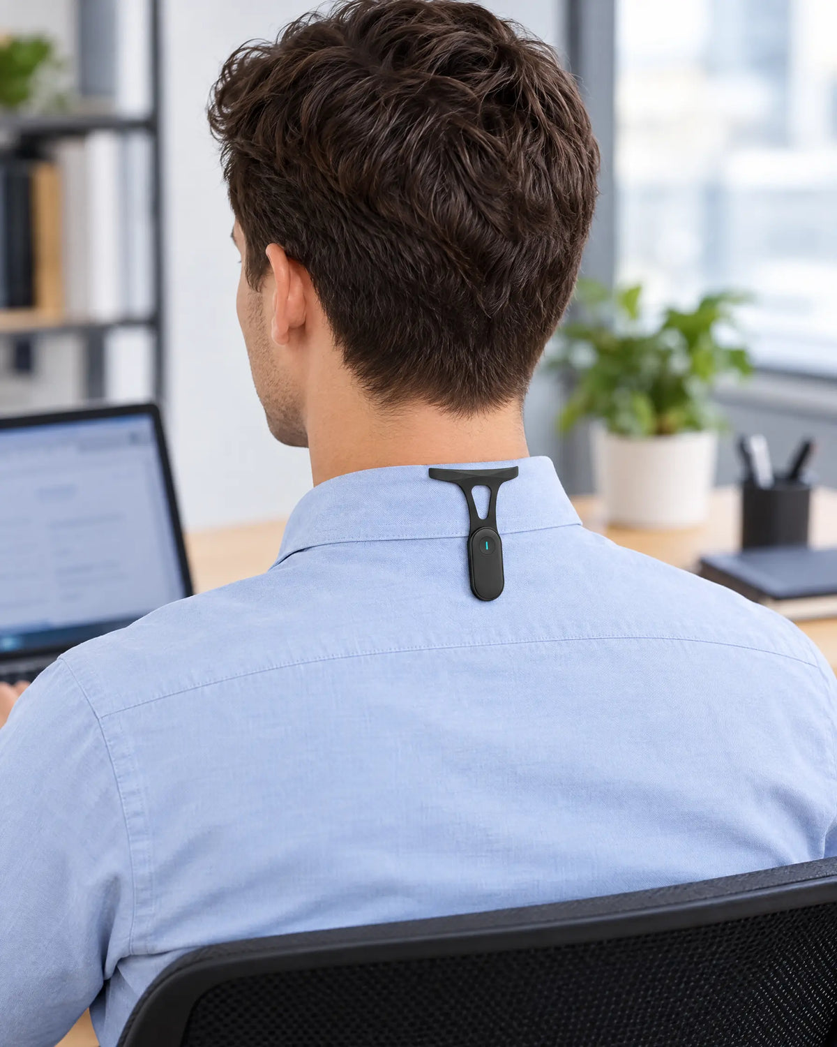 Posture trainer clipped to a shirt collar