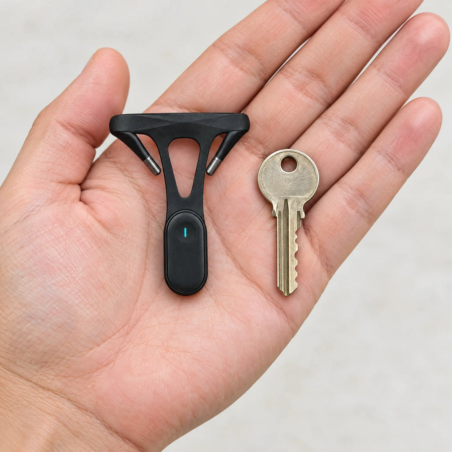 Posture trainer next to a house key