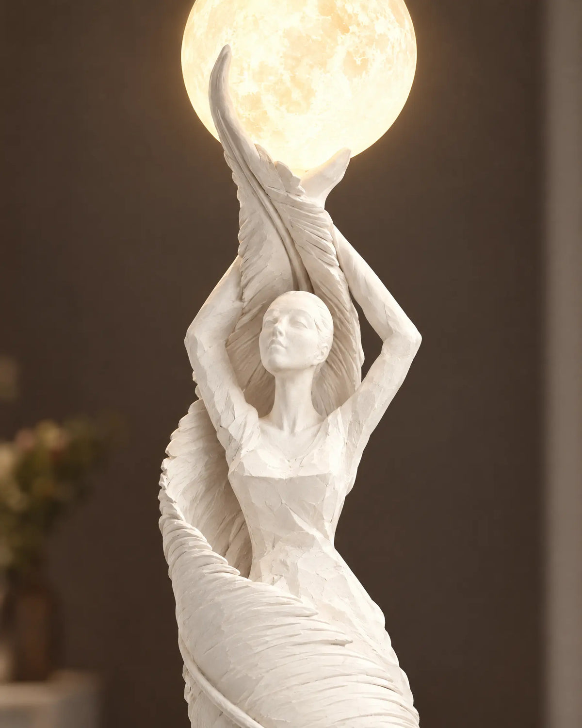 Close-up of the sculpted figure and glowing shade
