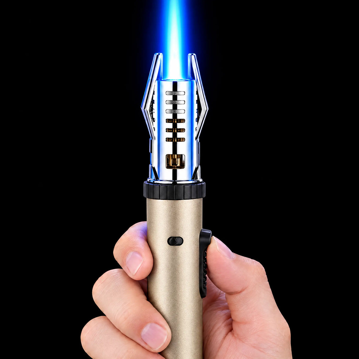 Gold torch lighter lit with a blue jet flame